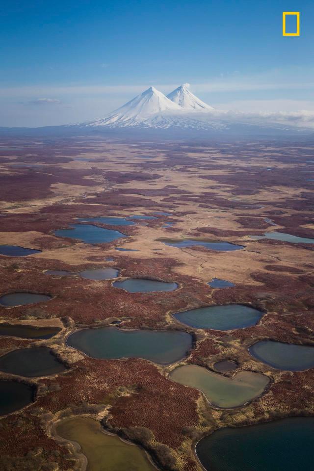  The views flying down to the Aleutian chain of Alaska by Toby Harriman with the peaks of Mount Pavlof and Pavlof Sister in the distance