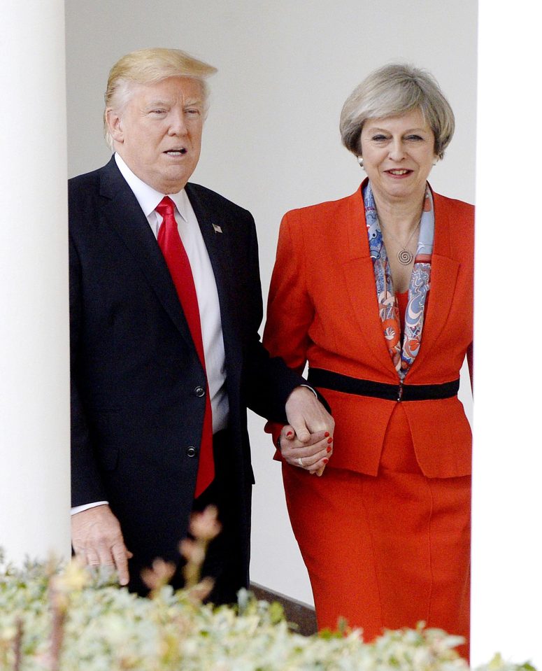  Donald Trump and Theresa May walk together at White House during her now notorious hand-holding visit