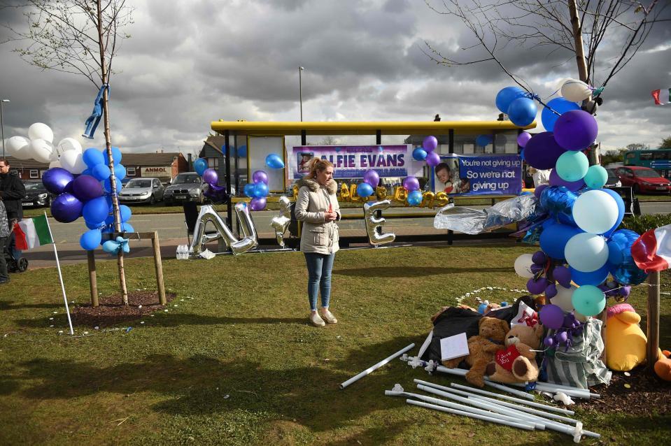  A lone woman stands at the abandoned protest site outside Alder Hey Hospital after Alfie's dad Tom told supporters to go home