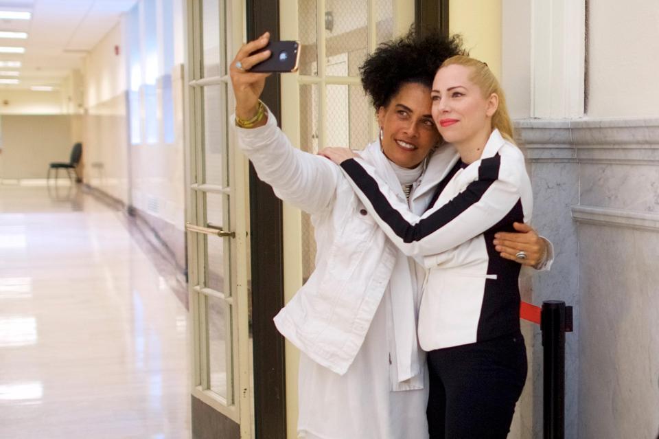  Accusers Lili Bernard, left, and Caroline Heldman, right, pose for a selfie outside Montgomery County Courthouse in Norristown, Pennsylvania