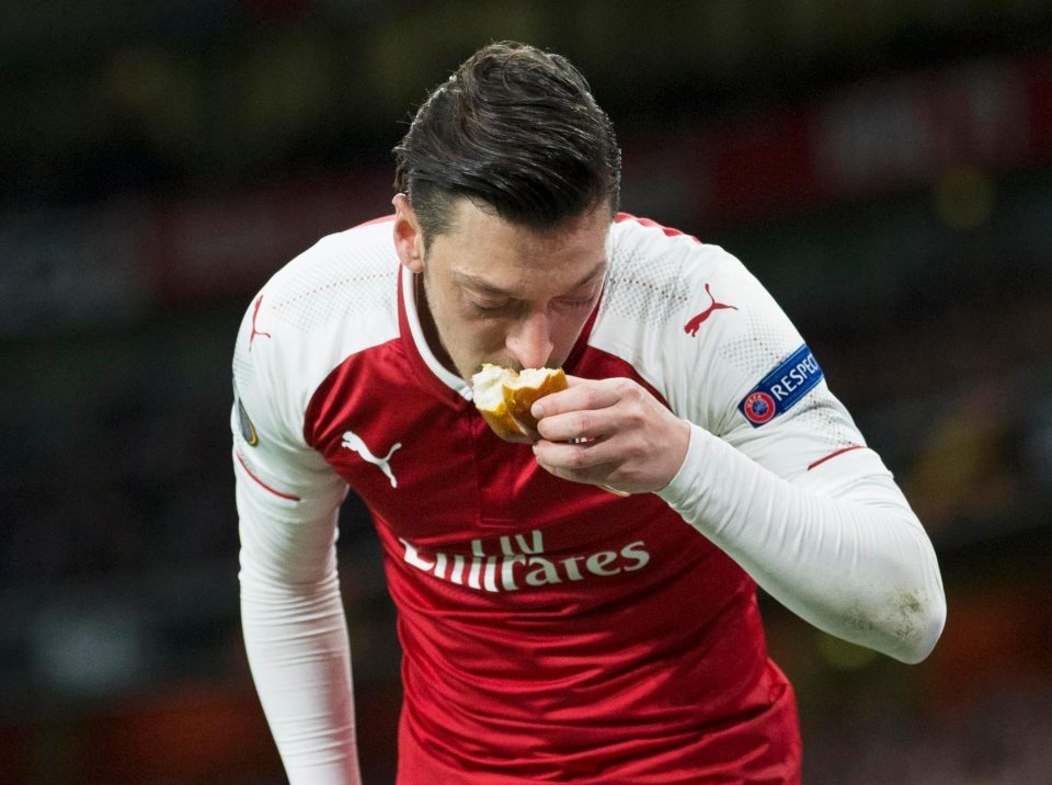  Atletico Madrid were charged for throwing objects onto the pitch - Mesut Ozil kissed a piece of bread that was thrown his way