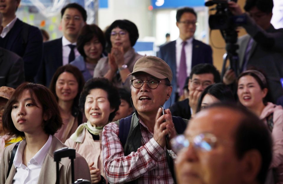  South Koreans watched as their leader met with his rival at a historic meeting on Friday