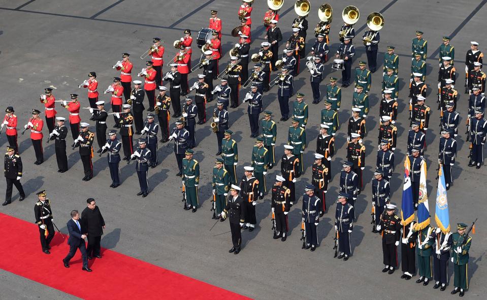  The leaders inspect an honour guard after Kim crossed the border into South Korea for their historic face-to-face talks