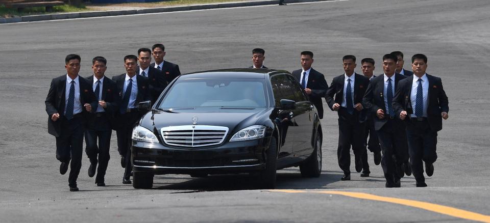  Kim Jong-un's battalion of bodyguards kept pace with the limo and changed formation as it went around a corner