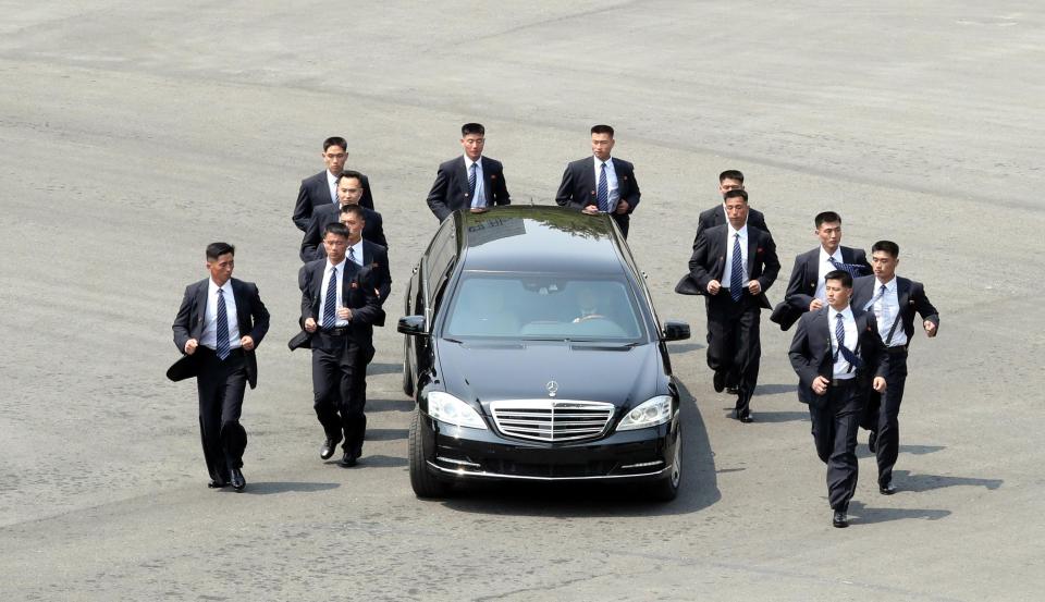  The North Korean dictator was flaked on all sides as he was driven off for lunch