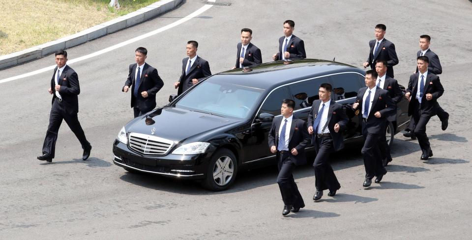  Kim's limo was flanked by jogging bodyguards as it made its way through Panmunjom