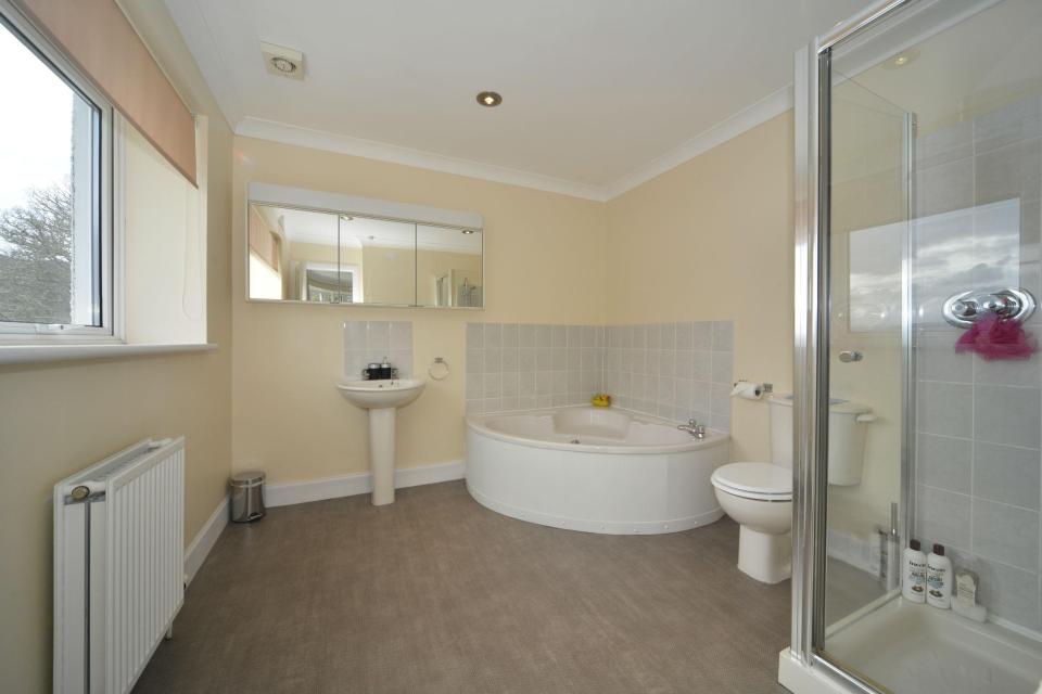  The master bedroom's en-suite bathroom boasts a corner bath