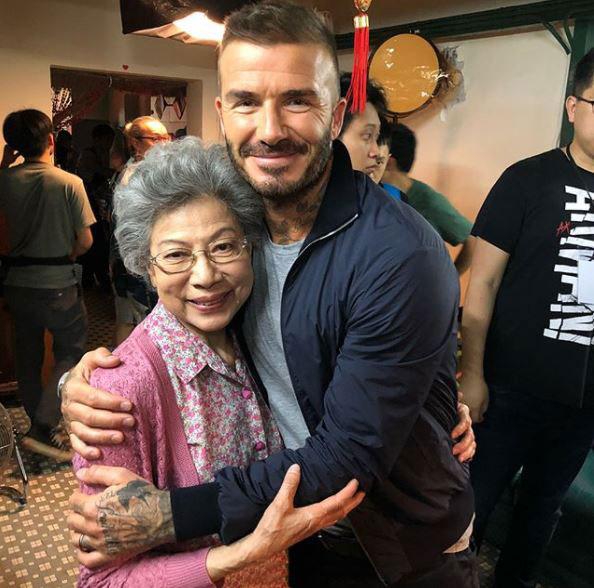  During a break from his shoot, David posed for pictures with locals