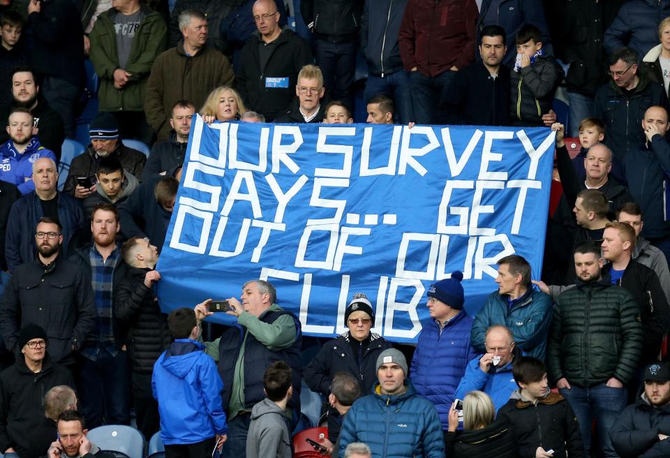  Everton fans hold up a banner in the away end during the win at Huddersfield