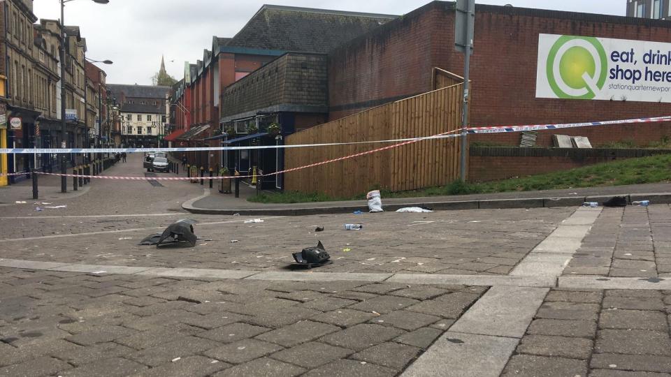  What appear to be pieces of a car bumper lie in the road at the crash site