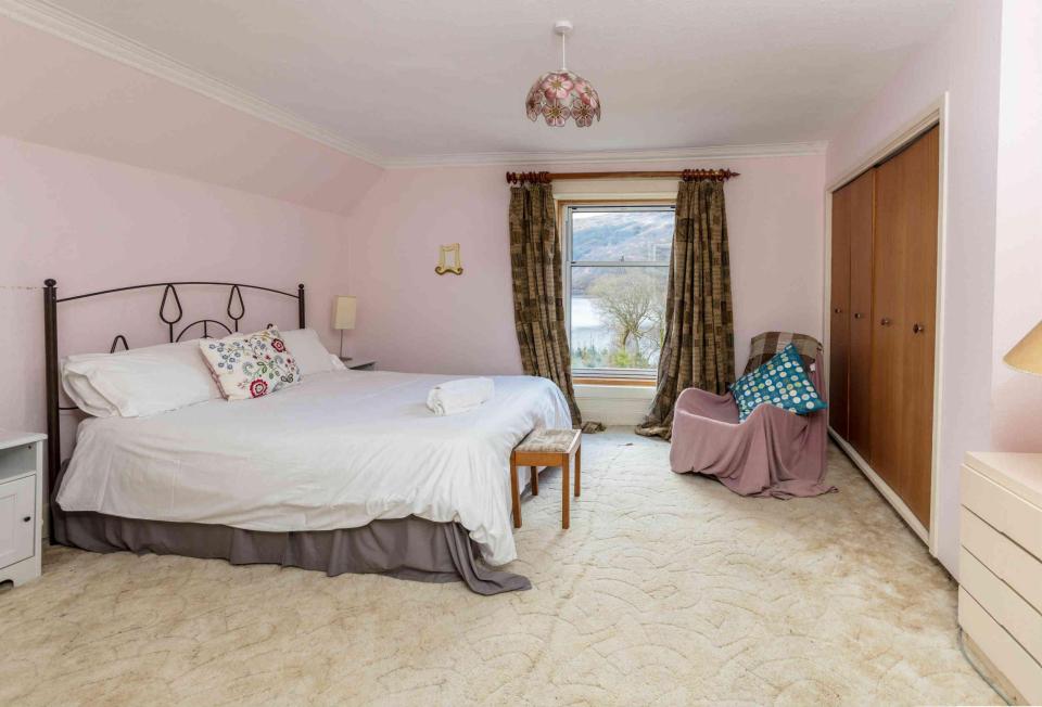  A bedroom features a picture postcard view of the loch below