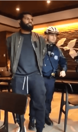  The footage, which was posted online, shows the two men being led out of the coffee shop in handcuffs