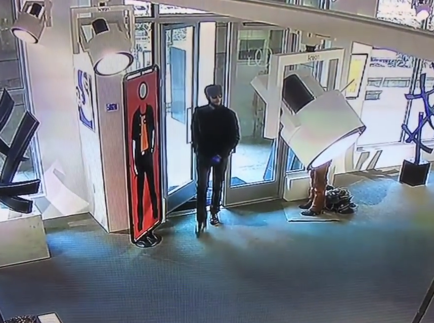  A man in dark glasses is seen entering the gallery in Aspen, Colorado