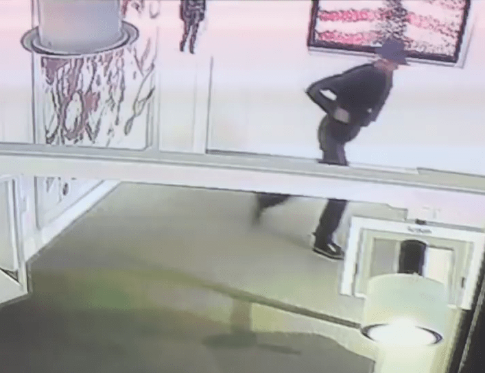  The vandal turns and runs after slashing the pricey piece of artwork