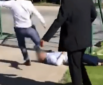  This is the moment a Goodwood racegoer kicks a man in the head as he lies unconscious