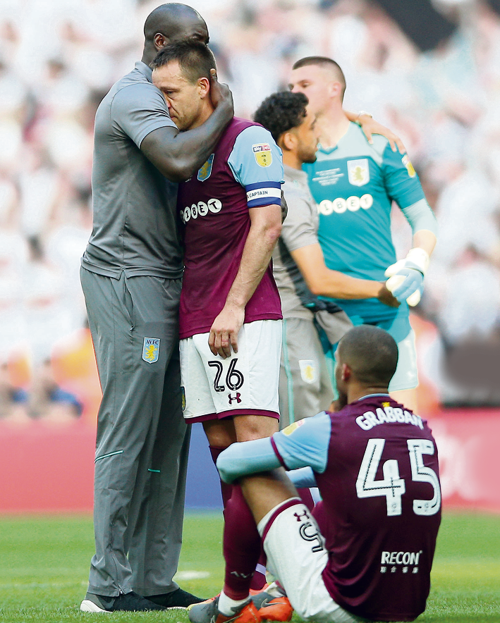 The pain is clear to see as John Terry is consoled by Villa staff and team-mates