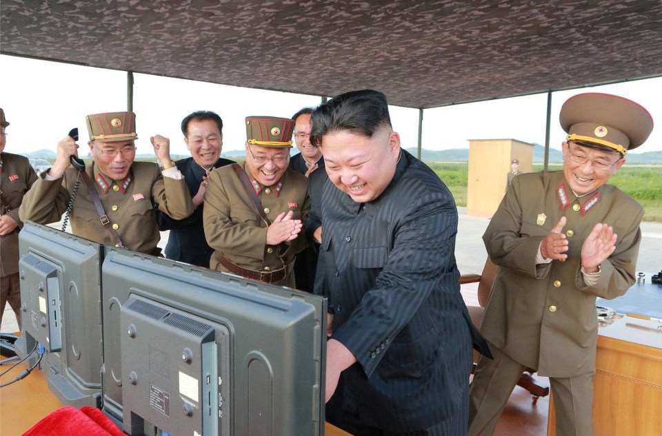 Kim with his top aides after a successful ballistics missile test last year