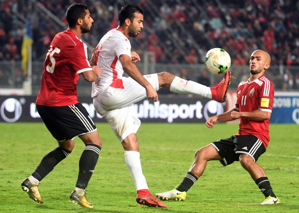  Tunisian forward Taha Khenissi vies for the ball against Libya