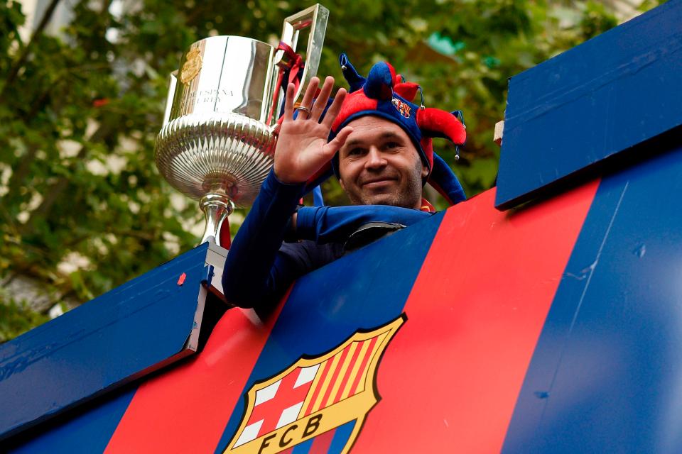  Andres Iniesta enjoys Barcelona's open top bus ride after league and cup double