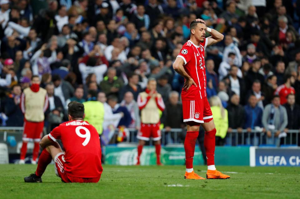  Bayern Munich players are dejected after facing elimination following late chances missed