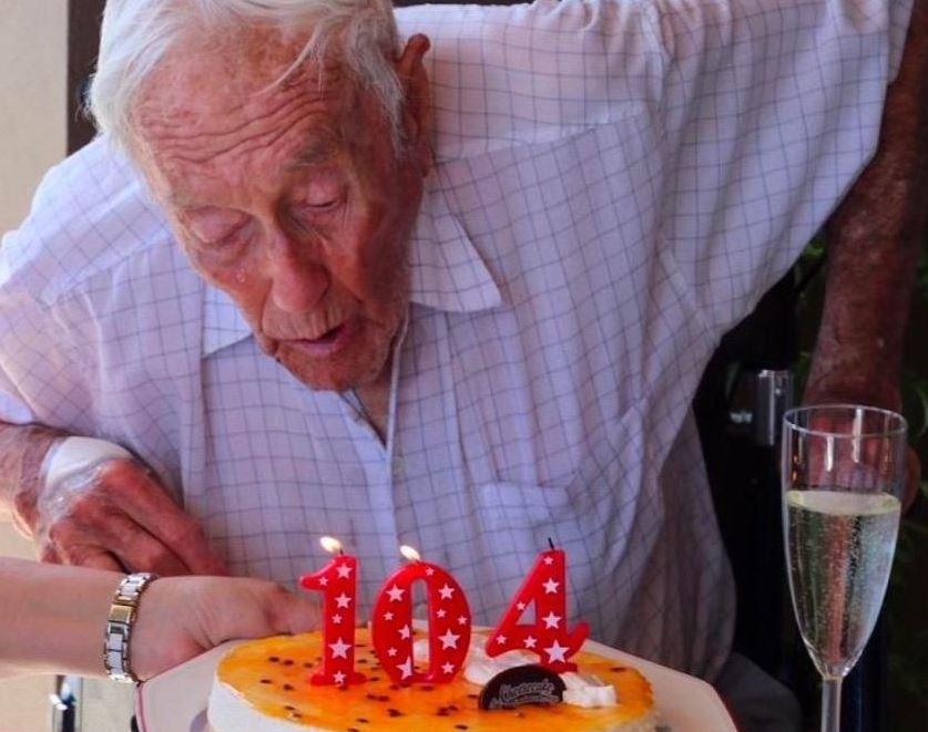  Dr David Goodall blowing out his 104 candle at his birthday party in April