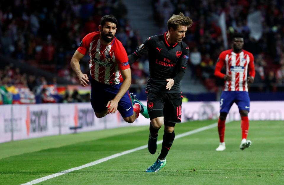  Diego Costa takes a tumble next to Arsenal defender Nacho Monreal