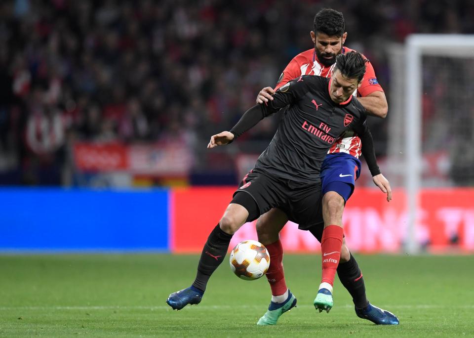 Mesut Ozil battles with Diego Costa in Europa League semi-final second leg