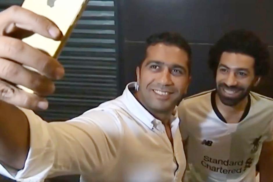 Bahaa poses for a selfie with a fan