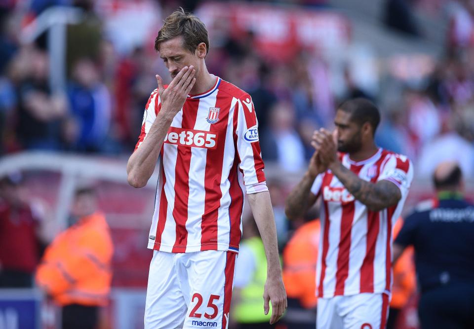  Peter Crouch and Glen Johnson trudge off the pitch at the bet365