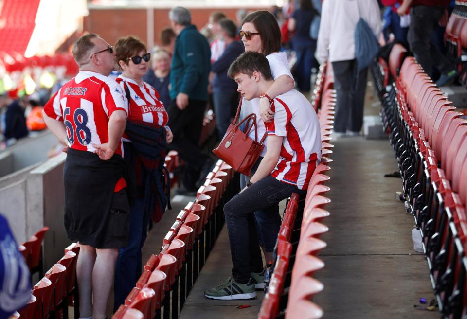  One fan is consoled by his mum after watching Stoke get relegated