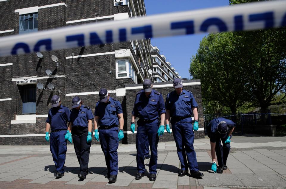  Police search teams carry out a finger tip search of the crime scene