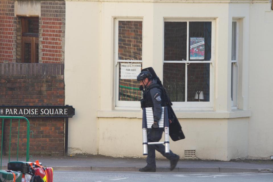  A special forces officer carries equipment through Paradise Square