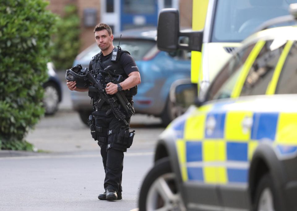  An armed cop keeps guard after the shootout between police and an armed gunman