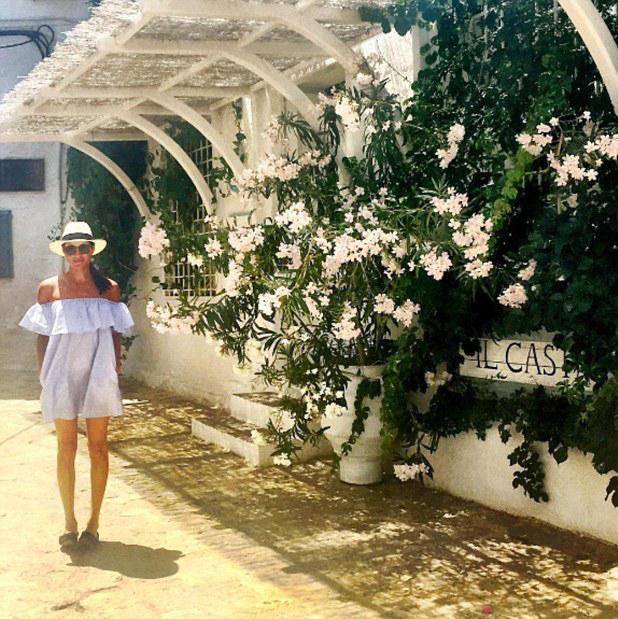  Meghan wearing a pale, off-the-shoulder sun dress in Greece