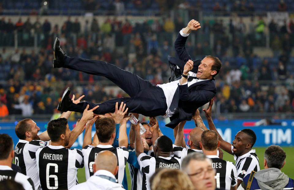  Massimiliano Allegri is hoisted into the air by his jubilant squad after the victory