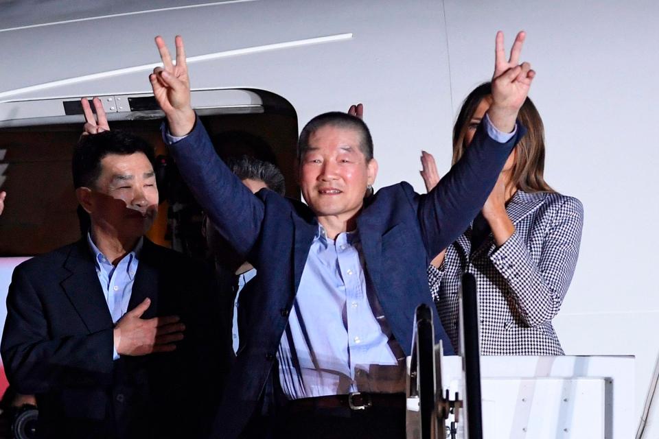  The trio flashed peace signs at the press after arriving back in the US