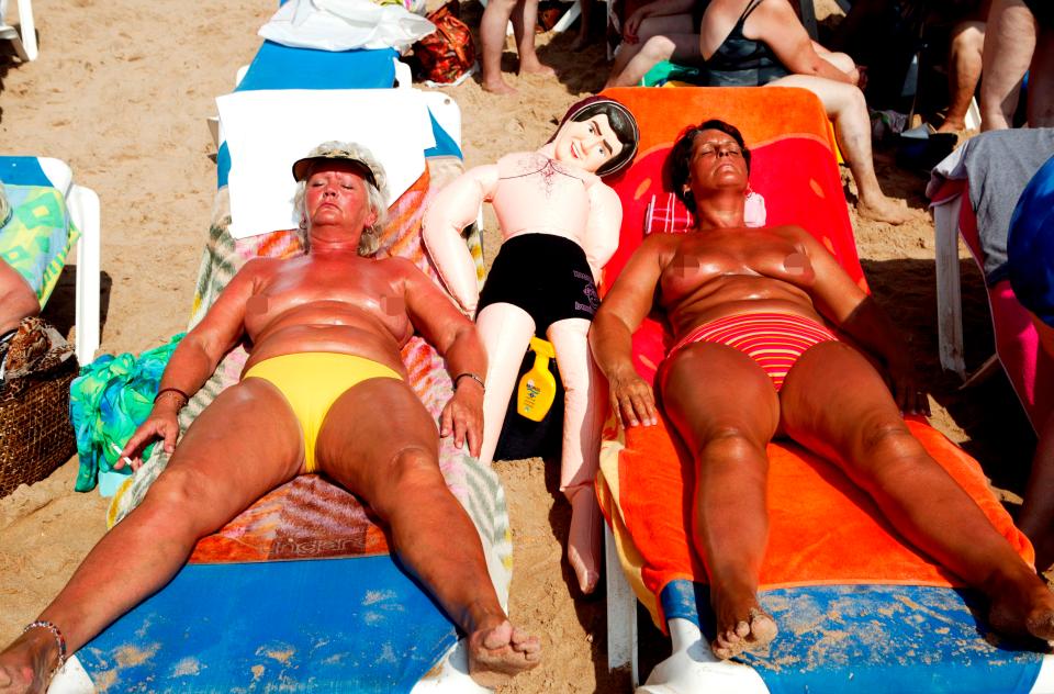  Two women enjoy a spot of topless sunbathing in 2004