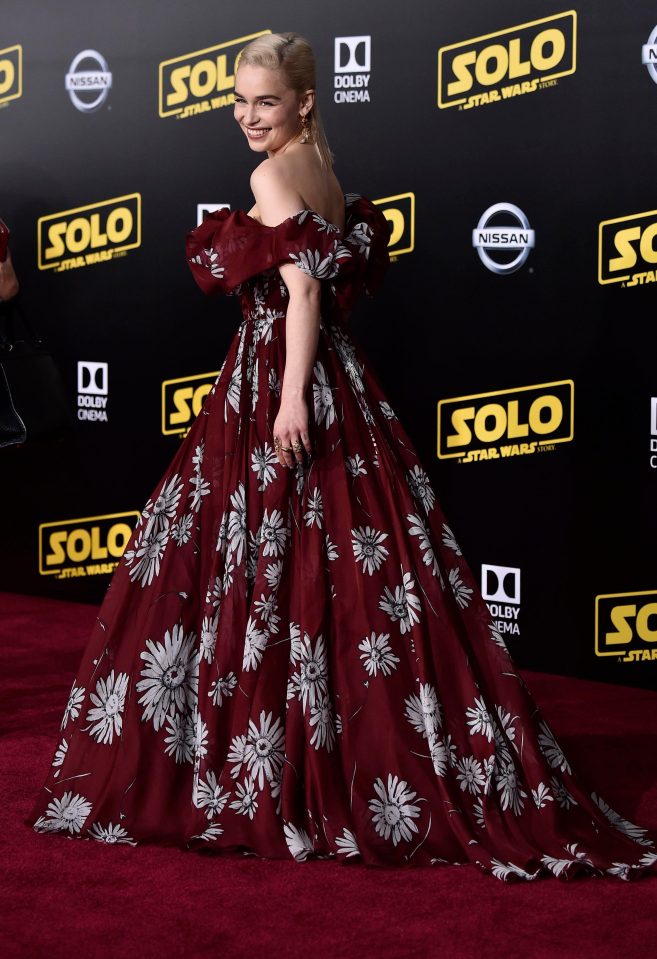  Emilia wore a burgundy Valentino gown which featured a floral detail