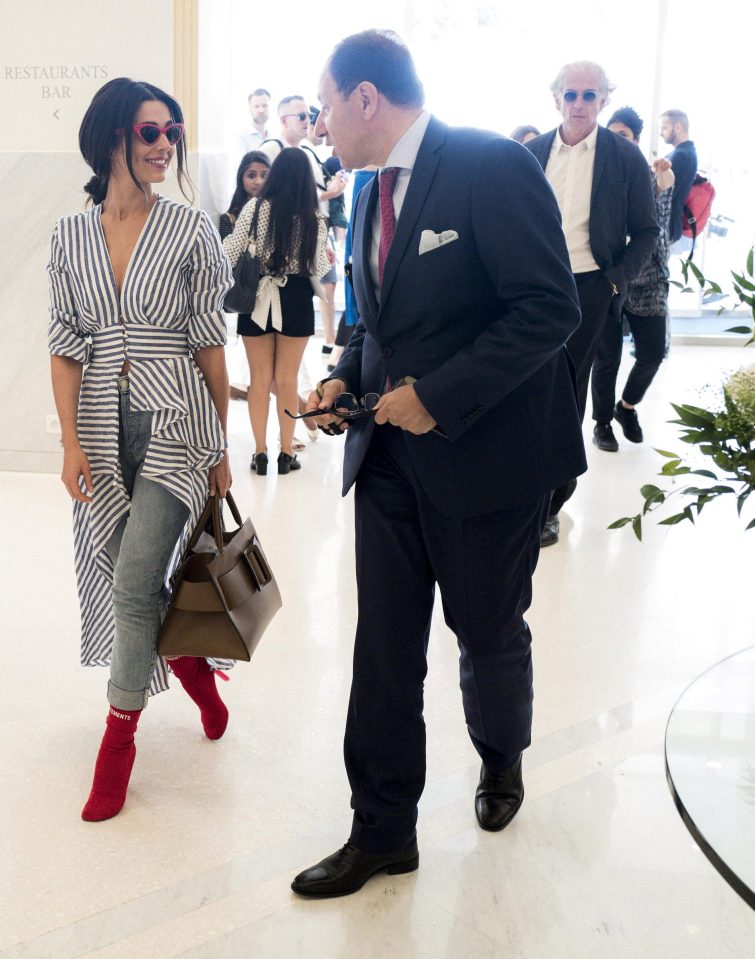  Cheryl teamed a blue and white shirt with a pair of jeans and bright red boots