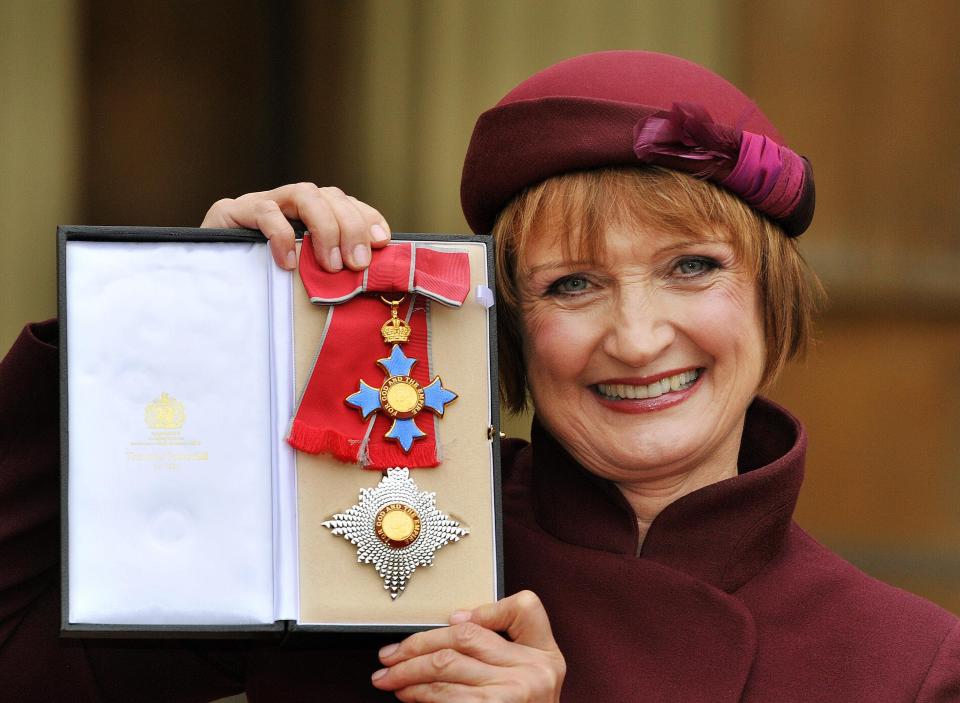  Dame Tessa Jowell proudly holding her Dame Commander insignia, after it was presented to her by the Prince of Wales