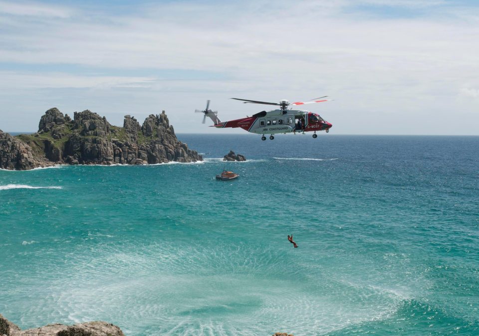  A Coastguard helicopter hovers over Pedn Vounder beach, near Porthcurno as part of an unrelated rescue