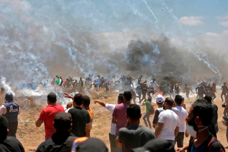  Tear gas canisters rain down from above as protesters run for cover