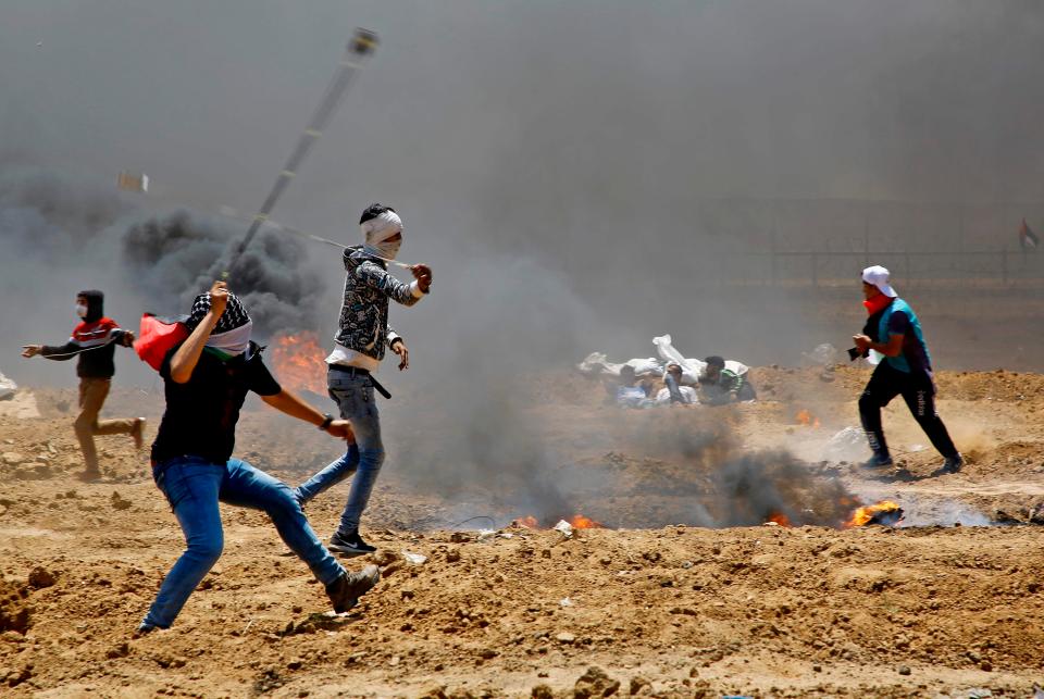  Protesters hurl stones towards the Israeli border today