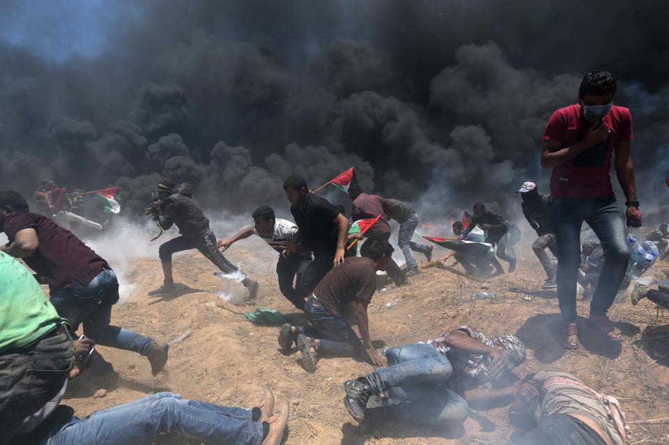  Palestinians drop to the ground for cover as gunshots ring out