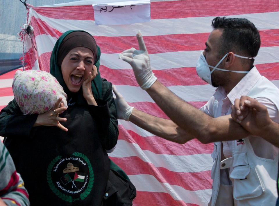  A Palestinian woman screams as she receives treatment in a first aid tent during the bloody protest near Beit Lahiya, Gaza Strip