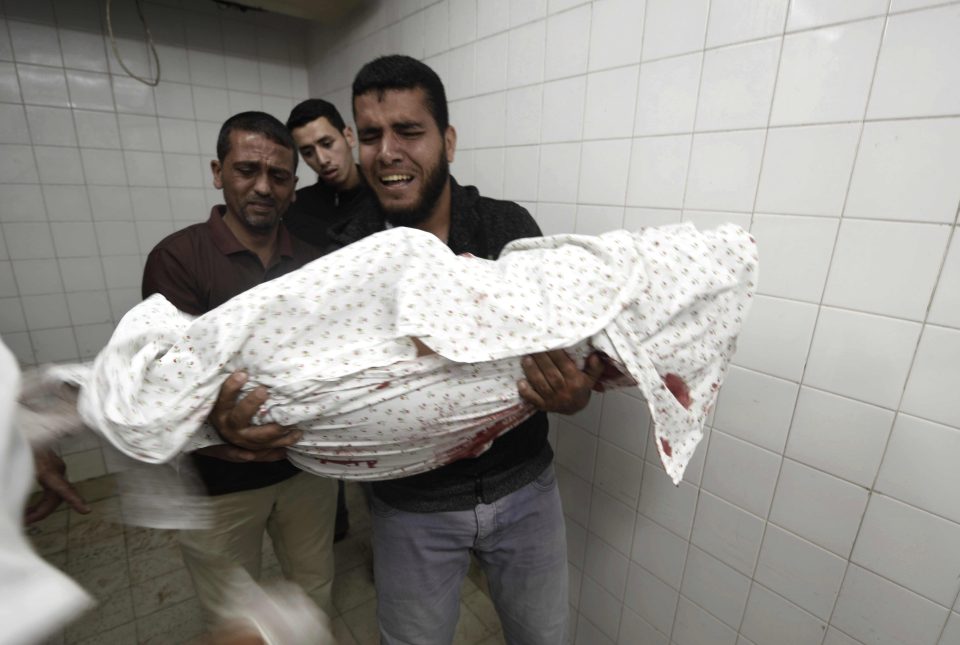  A sobbing Palestinian cradles the body of a dead protester in Gaza this week