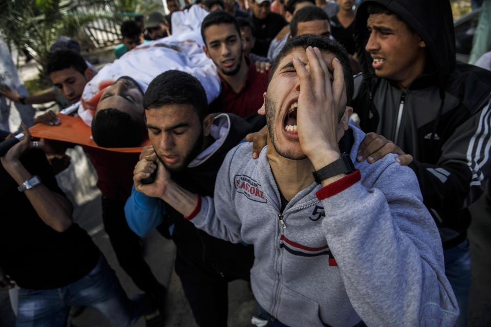  Relatives of a young man gunned down by Israeli forces are overcome with grief