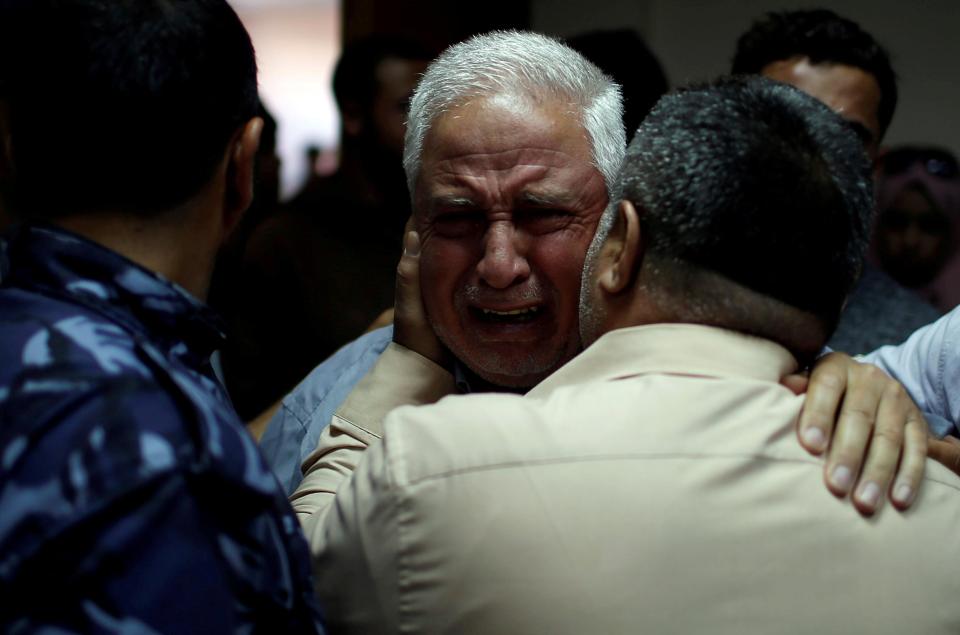  An elderly relative cries over the death of a man killed in the protest