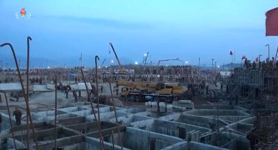  Photos from the ground show floodlights erected along the coast so construction can continue at night