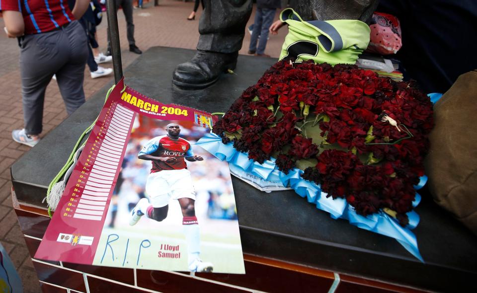  Aston Villa fans pay tribute to late Jlloyd Samuel with flowers before the match